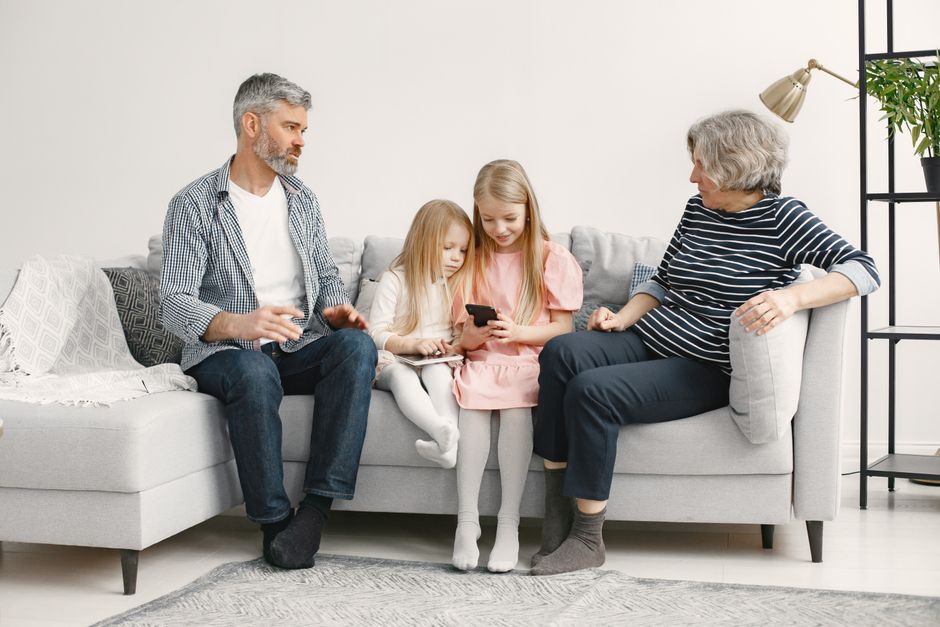 A cozy family on a couch in a warm living room during winter - emergency furnace replacement in waukee, ia A cozy family on a couch in a warm living room during winter - emergency furnace replacement in waukee, ia