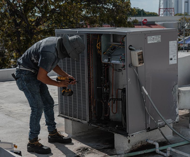 Technician professionally inspecting an outdoor AC unit - hvac inspection waukee