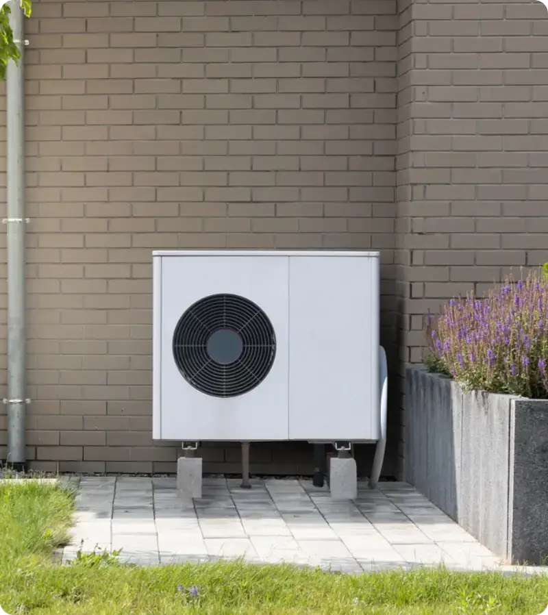 Sleek outdoor condenser unit installed neatly alongside a home's exterior wall Sleek outdoor condenser unit installed neatly alongside a home's exterior wall