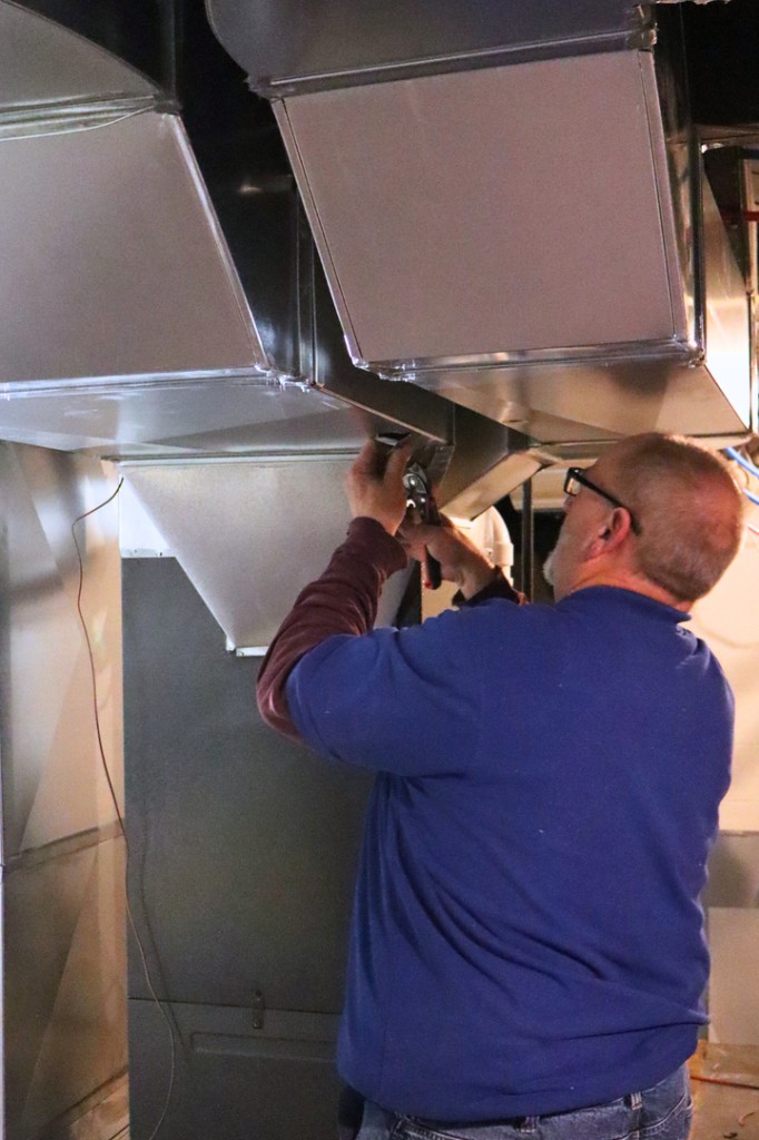 Ductwork installation by a Midwest Comfort technician