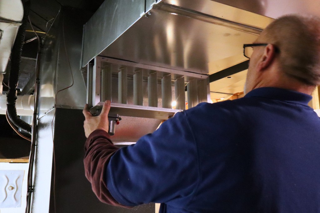 Midwest Comfort technician performing a Comfort Club seasonal tune-up