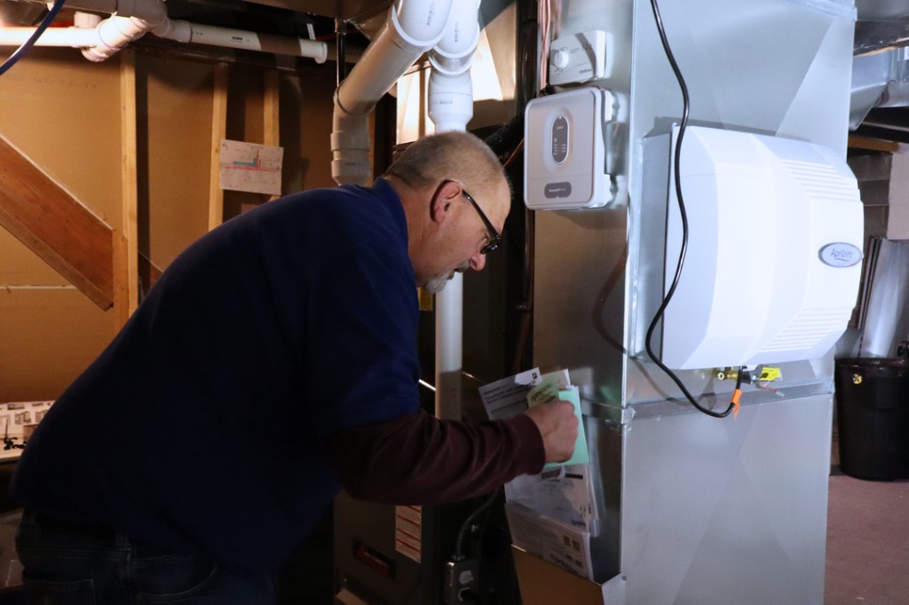 Midwest Comfort technician on a preventive maintenance visit