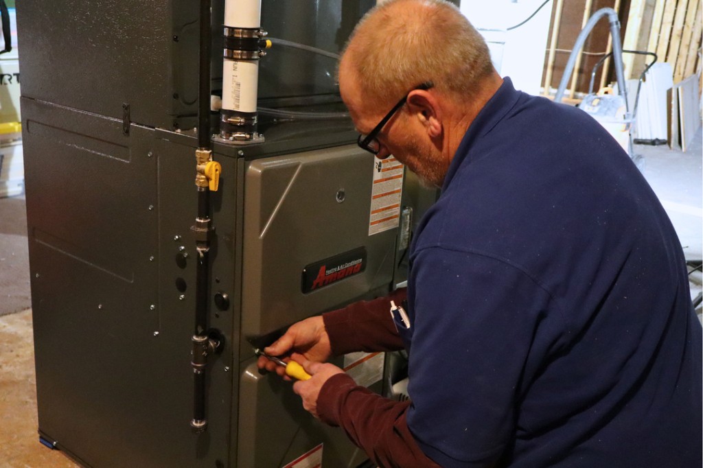 Midwest Comfort technician installing a residential furnace