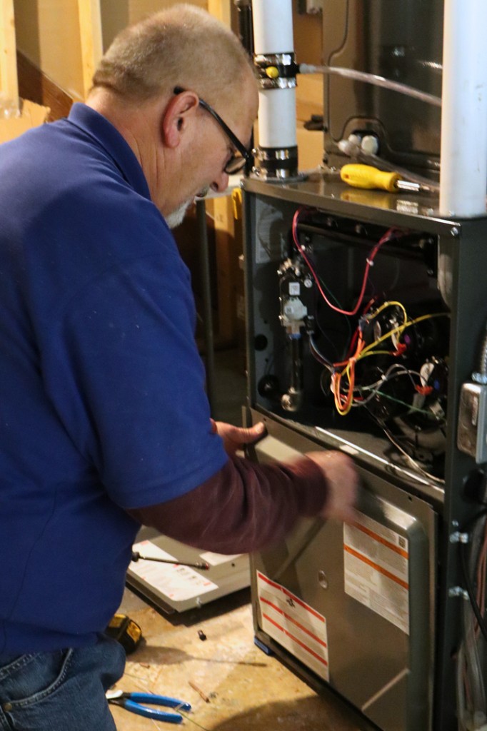 Midwest Comfort technician diagnosing a furnace issue