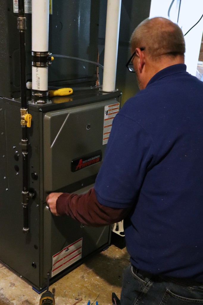 Midwest Comfort technician repairing a furnace