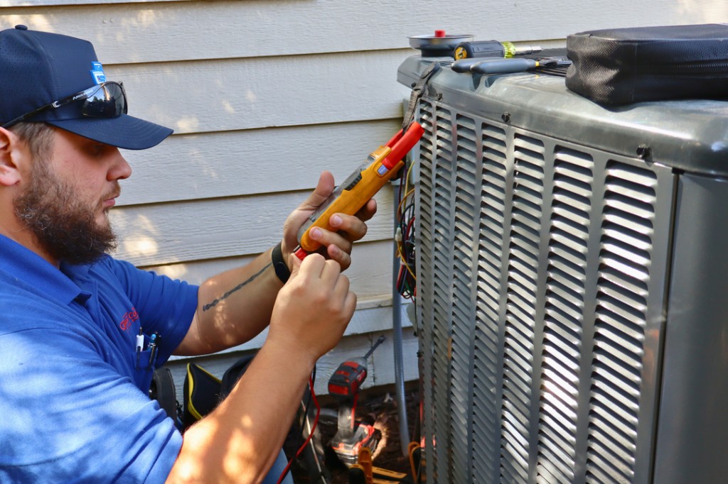 Older residential AC condenser being evaluated for repair versus replacement