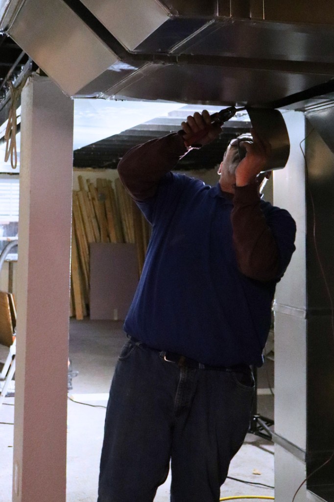 Midwest Comfort technician installing residential ductwork