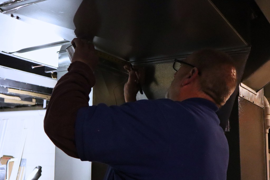 Midwest Comfort technician measuring residential ductwork